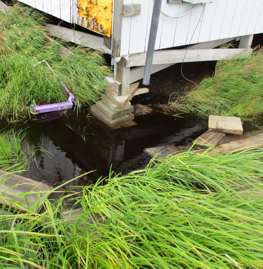 Edge of structure supported by blocks of wood